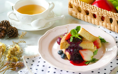 The bread is turned into triangles, stacked in layers, sprinkled with powdered sugar, decorated with cherries and mint leaves topped with cherry jam.