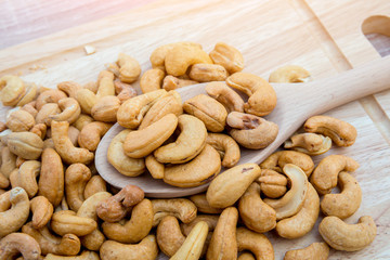 Tasty cashew nuts. The cashew tree is a tropical evergreen tree that produces the cashew seed and the cashew apple.