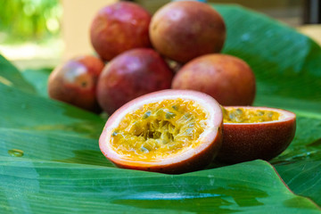 Ripe passion fruit, on a wet banana leaf. Vitamins, fruits, healthy foods