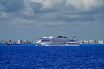 Huge modern cruiseship or cruise ship liner MSC Seaside at sea with skyline of Miami or South Beach...