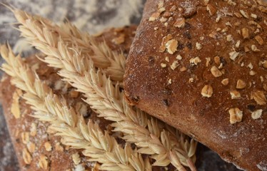 baked rye buns with cereal flakes and ears of wheat