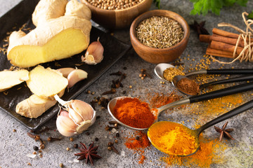 Various of Indian herbs and spices for cooking on a stone table.