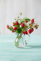 wild strawberries on turquoise surface