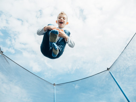young boy jumping on a trampoline