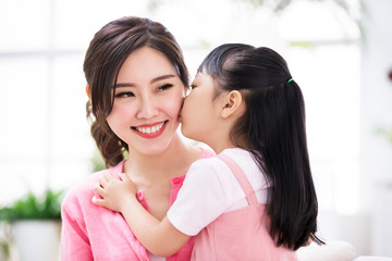Daughter kiss mom tenderly