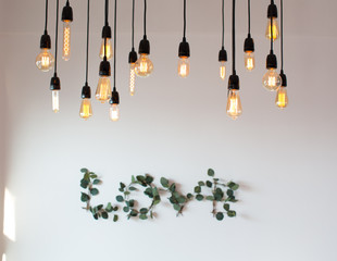 Set edison retro lamp on loft gray concrete background. Concept idea. Love. Warm.