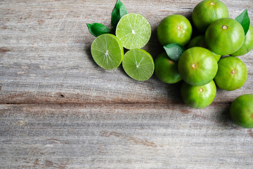 Top view of fresh citrus lemon lime on wooden background, copy space.