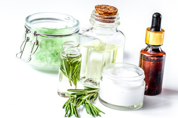 organic cosmetics with extracts of herbs rosemary on white background