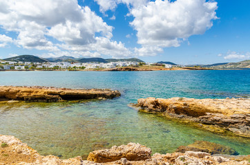 Rocky coast with crystal clear water in Naoussa village on Paros island. Cyclades. Greece.