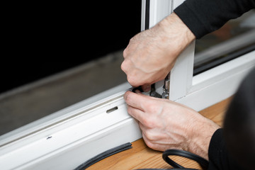 Professional master at repair and installation of windows, changes rubber seal gasket in pvc windows