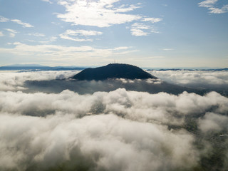 Aerial view Cherok Tokkun Hill over sea cloud in sunny day.