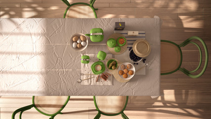 Vintage retro dining room in green tones with wooden table and chairs, breakfast buffet with cappuccino, fruit, eggs, cookies and cinnamon. Interior design, top view, plan, above