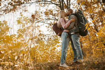 Young Couple Of Tourists Kissing in Forest Outdoors