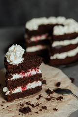 Chocolate cake with cream and raspberries. Cut piece