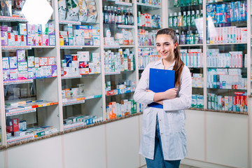 pharmacist chemist woman working in pharmacy drugstore with tablet.
