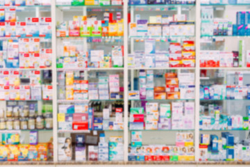 Obraz na płótnie Canvas counter store table pharmacy background shelf blurred blur focus drug medical shop drugstore medication blank medicine pharmaceutics.