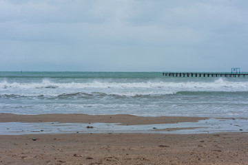 eashore in cloudy weather with sky covered by clouds