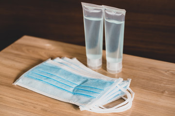 Hand sanitizer gel Anti virus protection and medical surgical masks with standard to prevent coronavirus COVID-19 infection.Medical protective on wood background.Healthcare and medical concept.