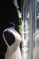 wedding dresses on mannequins in front of the window