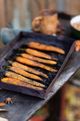 the process of making fresh carrots on a black pan