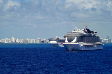 Cruiseships or cruise ship liners parked or anchored or laid up at sea in Miami Beach Florida due...