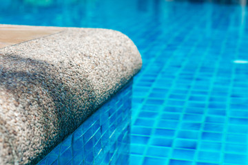 edge of the pool with crystal blue water