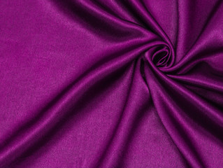 Smooth elegant pink silk or satin luxury cloth texture can be used as abstract background. Crumpled fabric Twisted at the side.