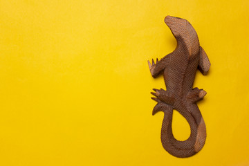 lizard figure on yellow background