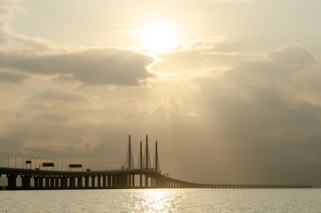 Fototapeta na wymiar Morning sun ray through the cloud at Penang second bridge.