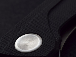 Folding knife with G10 grip and a shiny axial screw