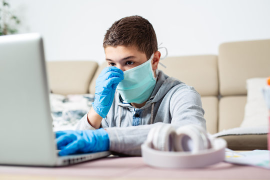 Boy with computer does his homework during a coronavirus quarantine. concept of online education. 