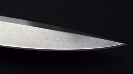 Folding knife blade on black background