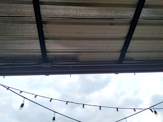 The metal sheet roof and blue sky.