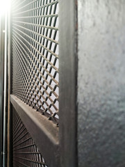 Wire netting or metal fence net and out of focus background.