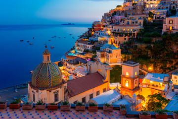 Positano, Amalfi Coast, Campania, Sorrento, Italy. View of the town and seaside in a summer sunset