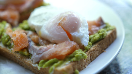Tasty sandwich with Salmon Poached Egg Avocado. Gourmet Food