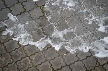 Public janitor deep cleaning the sidewalk with high pressure disinfectant solution in times of corona virus pandemic in a lockdown Bucharest, Romania