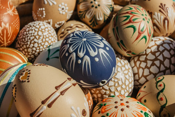 Full background of colorful, hand painted Easter eggs. Easter eggs in a wooden basket.Spring decoration. Painted Easter eggs.Festive tradition.Selective focus.Handmade Easter eggs