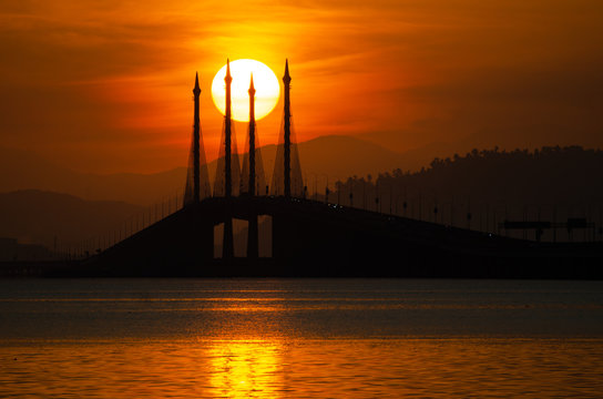Silhouette nature egg yolk sunrise at Penang Bridge.