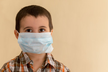 Toddler boy in a medical mask. Covid-19 virus protection. copy space