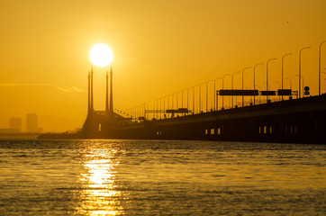 Golden egg yolk sunrise at Penang Bridge.