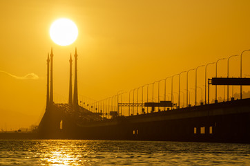 Obraz premium Gold sun rise over architecture cable stayed Penang Bridge.