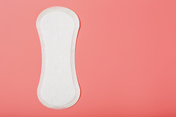 Sanitary pad on a pink background. Free space, isolate.