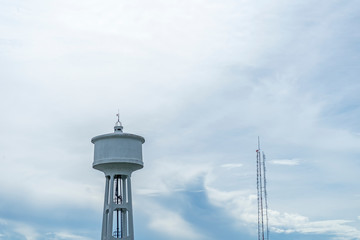 Water tank and signal towers and sky and clouds background