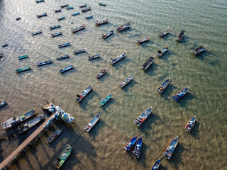 Fishing boats in row at jetty.