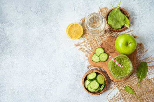 Diet And Detox Concept. Green Smoothie Wirh Spinach, Cucumber And Apple Over Rustic Background. Top View From Above