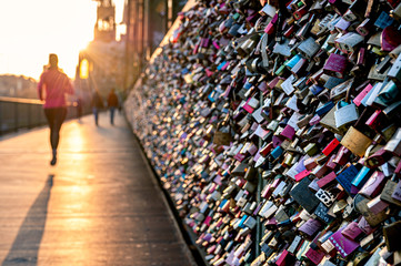 Love locks on the bridge in evening light. Hohenzollernbridge, Cologne, Germany.