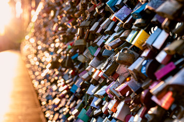 Love locks on the bridge in evening light. Hohenzollernbridge, Cologne, Germany.