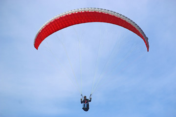 Paraglider flying wing in a blue sky	