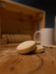 cookies on wooden background with a mug and coffee beans.